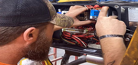 Hoist technician inspecting an overload drive inside of an R&M Hoist.